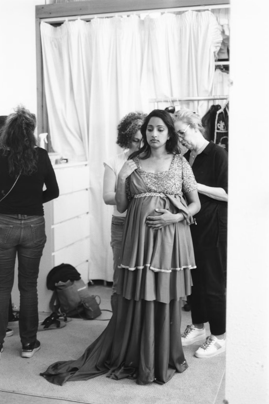 Maya Kherani being fitted for a costume backstage while pregnant